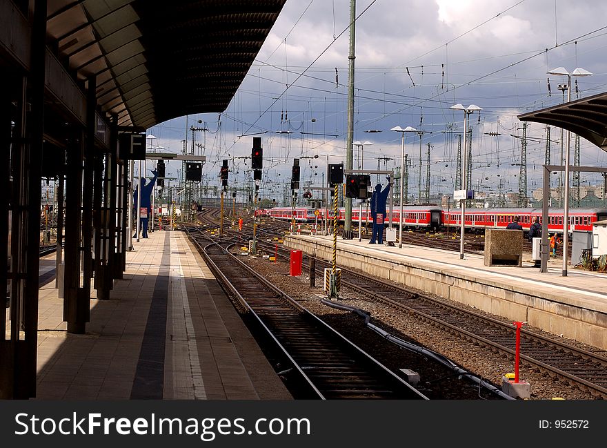 German Train station platform with departing train