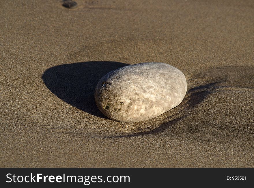 Light pebble on dark sand