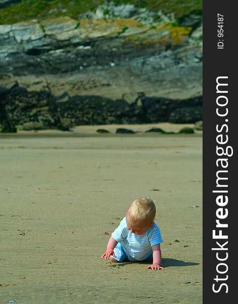 Small child exploring a beach in Cornwall. Small child exploring a beach in Cornwall.