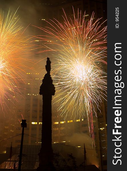 A downtown fireworks display performed in a downtown setting against a skyscraper