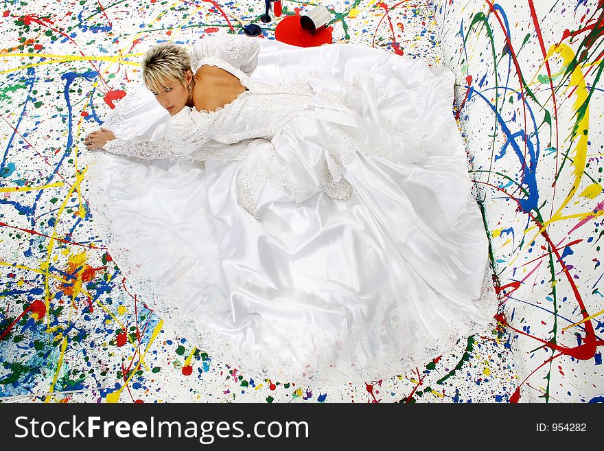 Beautiful young woman in bridal gown; splattered paint background; full body. Beautiful young woman in bridal gown; splattered paint background; full body