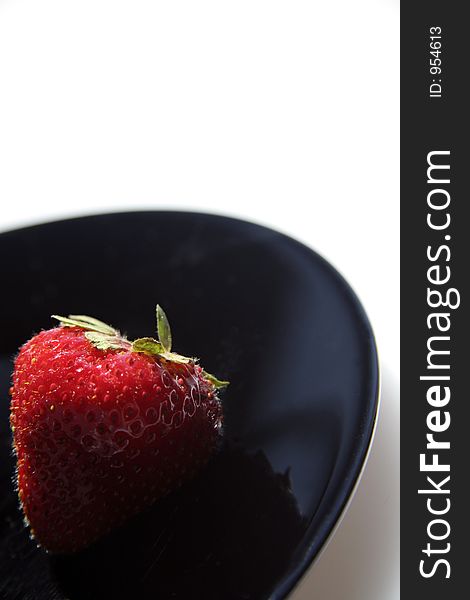 Picture of a strawberry on black plate