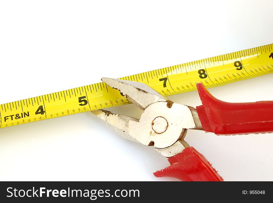 Pilers cut measure tape on white background. Pilers cut measure tape on white background