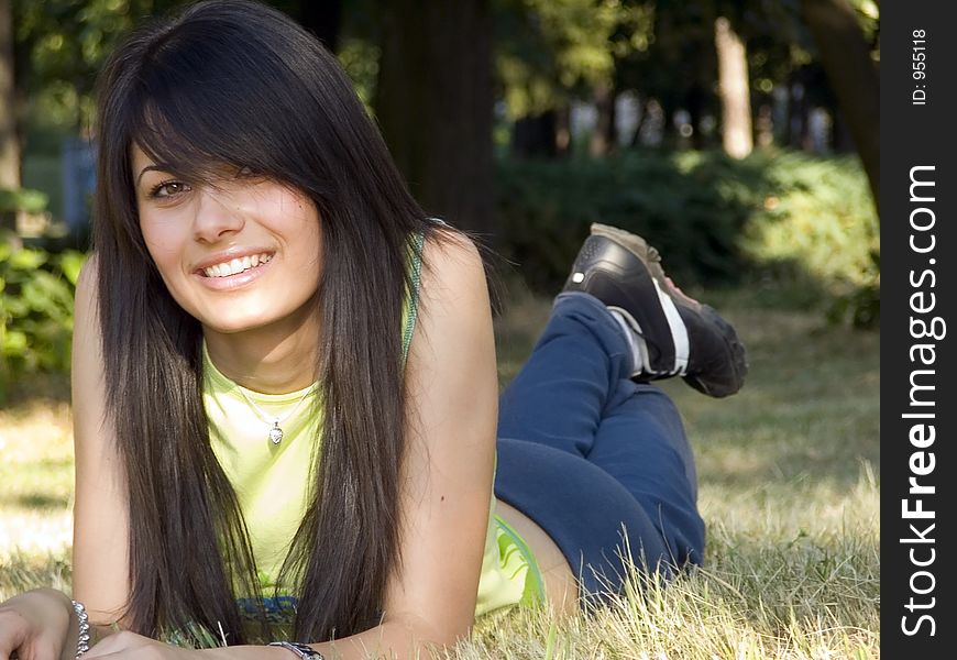 Beautiful girl lying on grass and smiling. Beautiful girl lying on grass and smiling