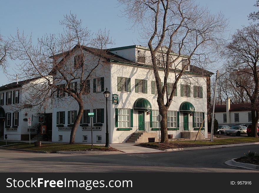 Moffat Inn, Niagara on the Lake, Canada. 3-storey white building with green door and windows.