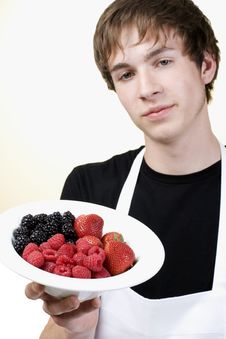Young Cook Holding A Serving Of Berries Royalty Free Stock Image Young Cook Holding A Serving Of Berries Royalty Free Stock Image