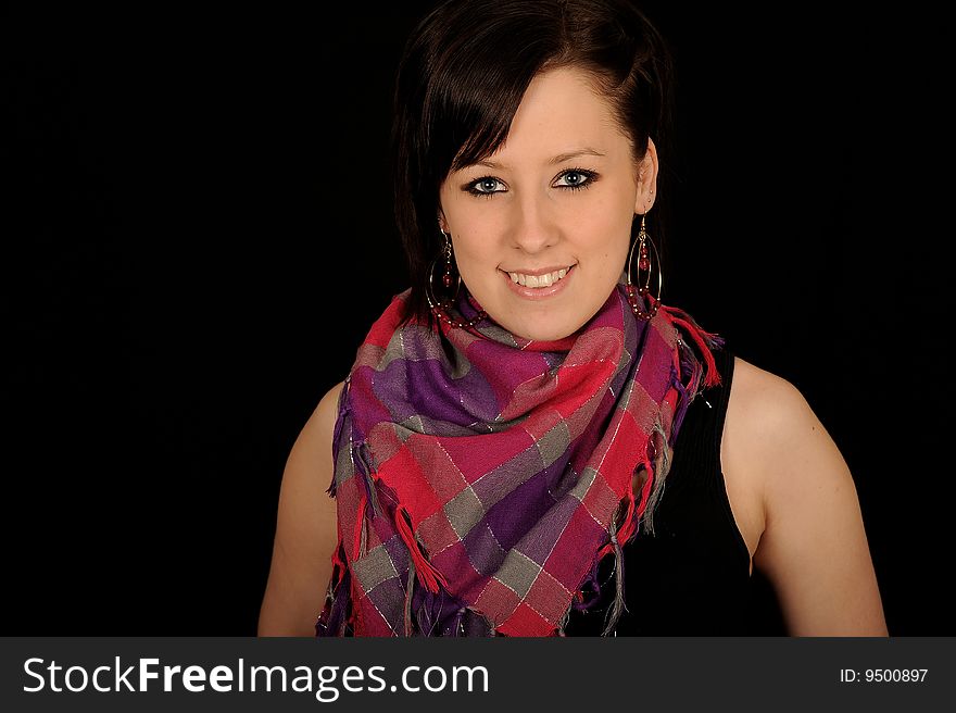 Horizontal closeup portrait of a smiling young woman, isolated against a black background. Horizontal closeup portrait of a smiling young woman, isolated against a black background.