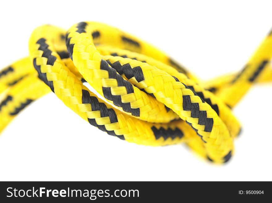 Knot of two yellow and black cords. Knot of two yellow and black cords