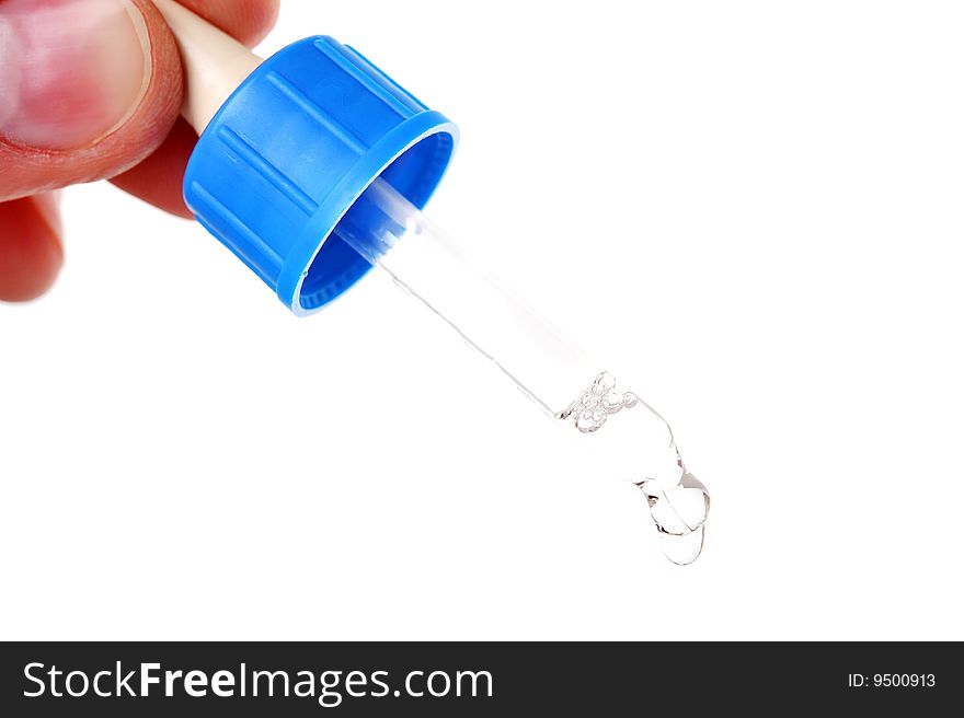 Pipette with oil nose drops in hand