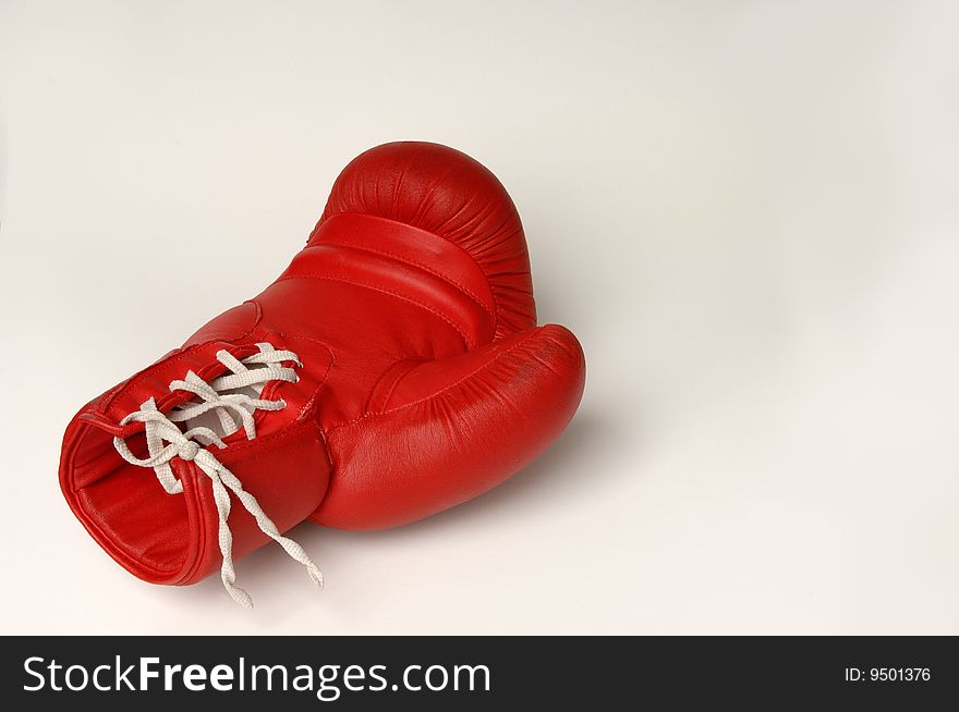 Red boxing glove with white lacing