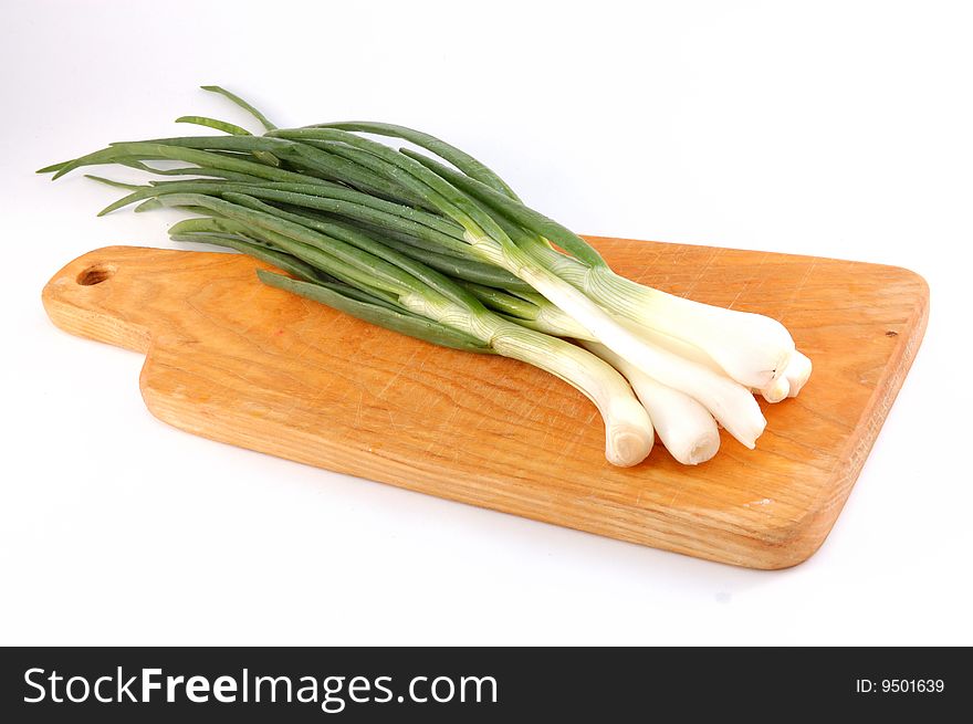 Spring onions on the threaded board