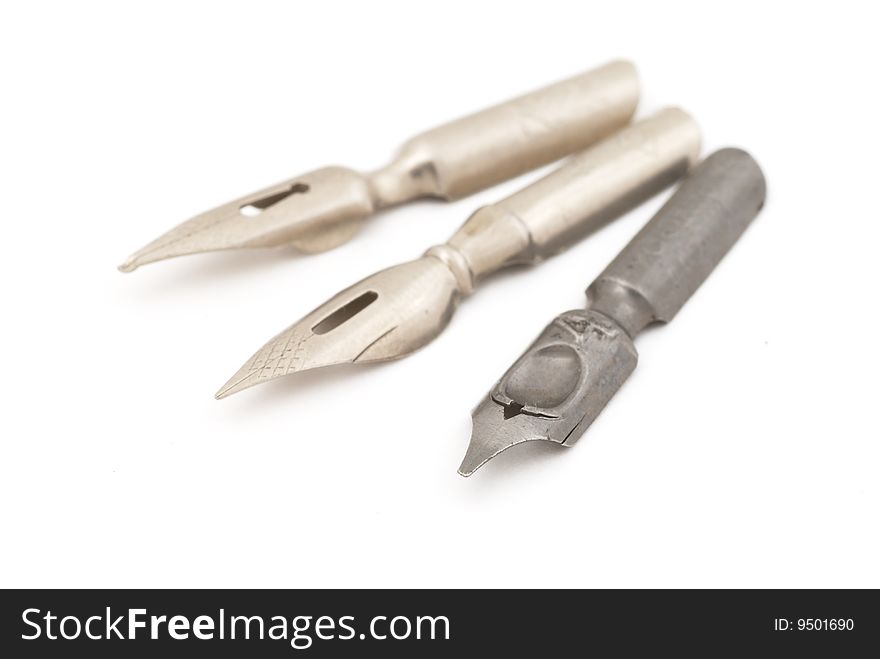 Old silver and steel fountain pens. Selective focus