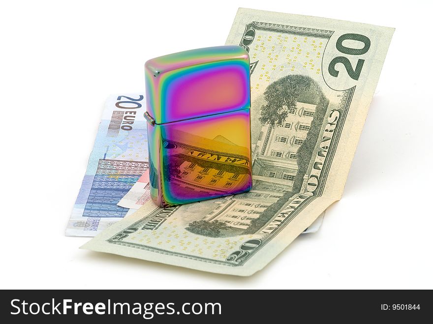 Golden metal cigarette lighter. Euro and dollar banknotes. Selective focus