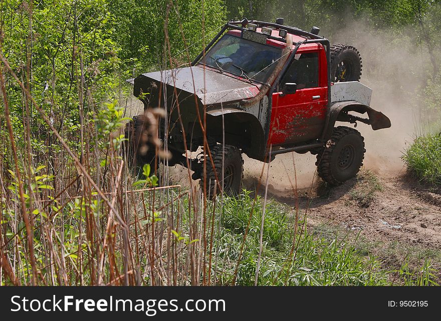 Off-road car stiring up the dust