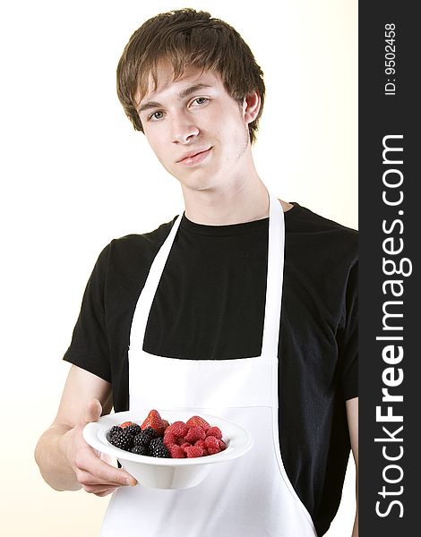 Young Man Holding A Bowl Of Fruit