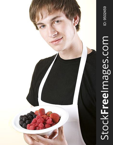 Young Man Holding Bowl Of Berries
