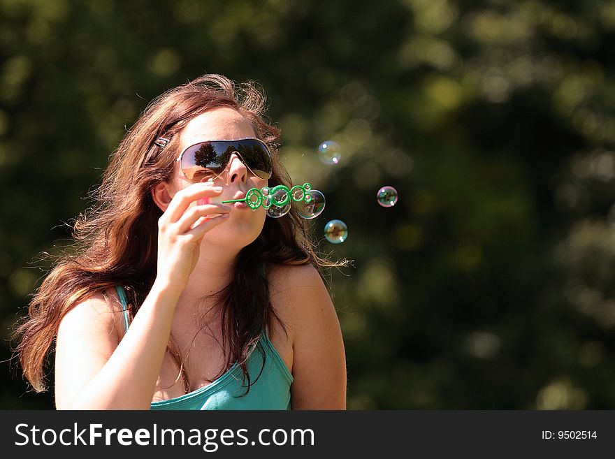 Girl blows in free many bubbles. Girl blows in free many bubbles