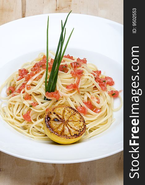 Plate Of Linguine Topped With Diced Tomatos