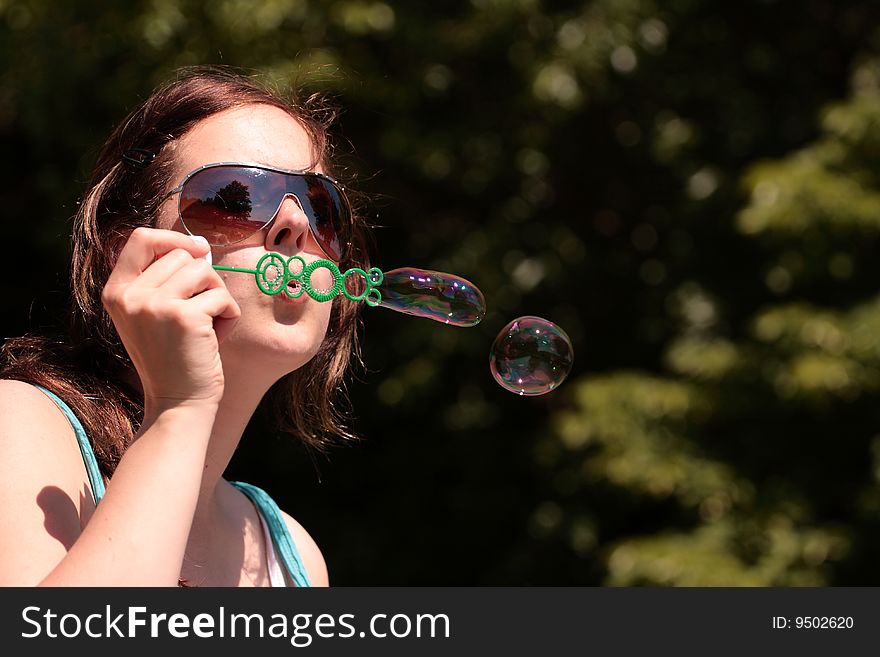 Girl blows in free bubbles. Girl blows in free bubbles