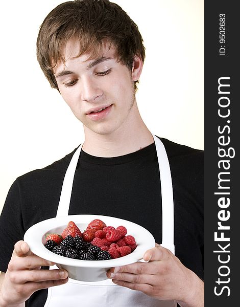 Young Man Looking Down At A Serving Of Berries