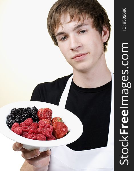 Young Cook Holding A Serving Of Berries