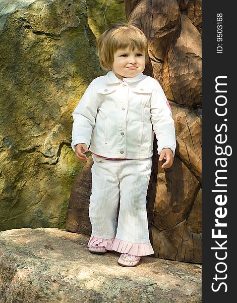 Young girl in park on the stone