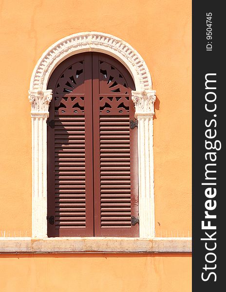 Beautiful windows and a orange wall in piazza Signoria, Verona, Italy. Beautiful windows and a orange wall in piazza Signoria, Verona, Italy