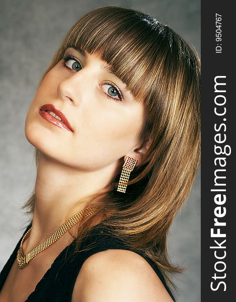 Girl in a black elegant dress on a grey background. Girl in a black elegant dress on a grey background