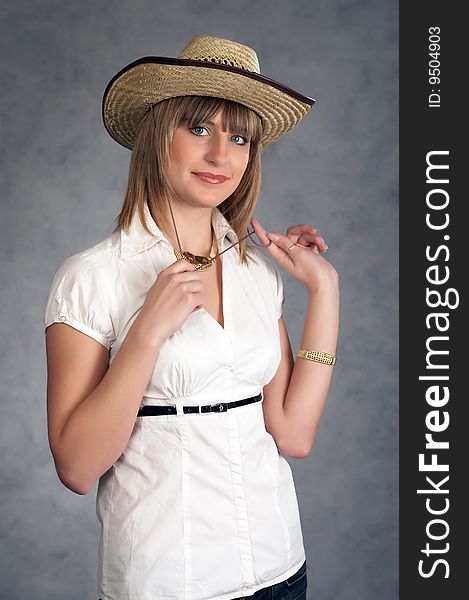Cowgirl In A Hat On A Grey Background