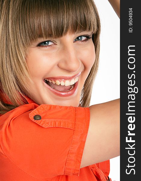 Close up of glamor girl in a orange dress isolated on white posing in a studio