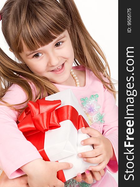 Adorable little girl with white gift box