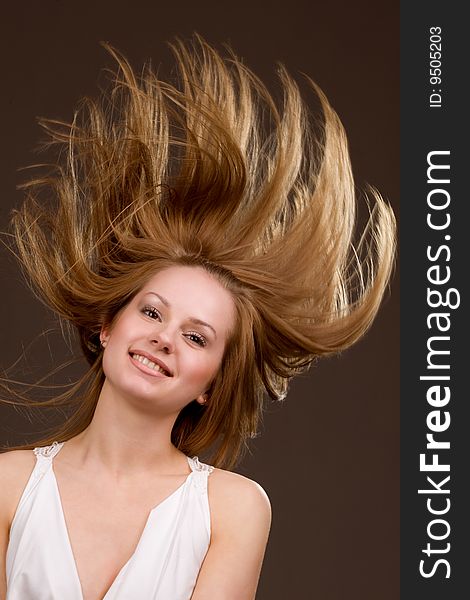 Happy young  girl with long flying hair