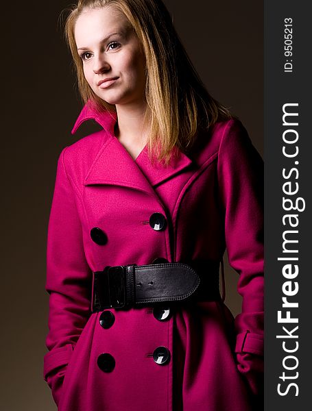 Young fashionable woman wearing purple coat
