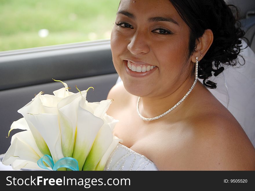 Hispanic bride waiting in the car before the wedding