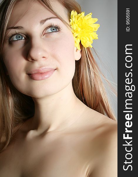 Beautiful young woman with yellow flower. Beautiful young woman with yellow flower