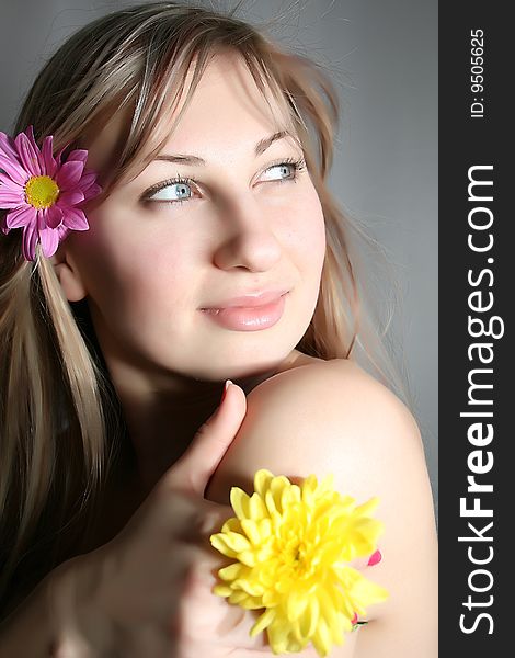 Beautiful young woman with yellow flower. Beautiful young woman with yellow flower