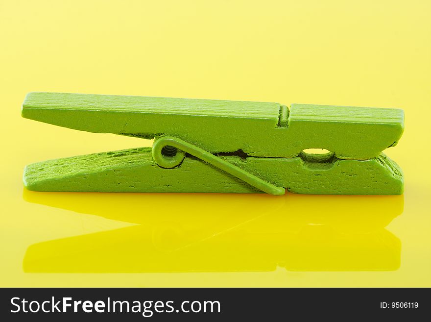 Stiled clothespin on yellow glass