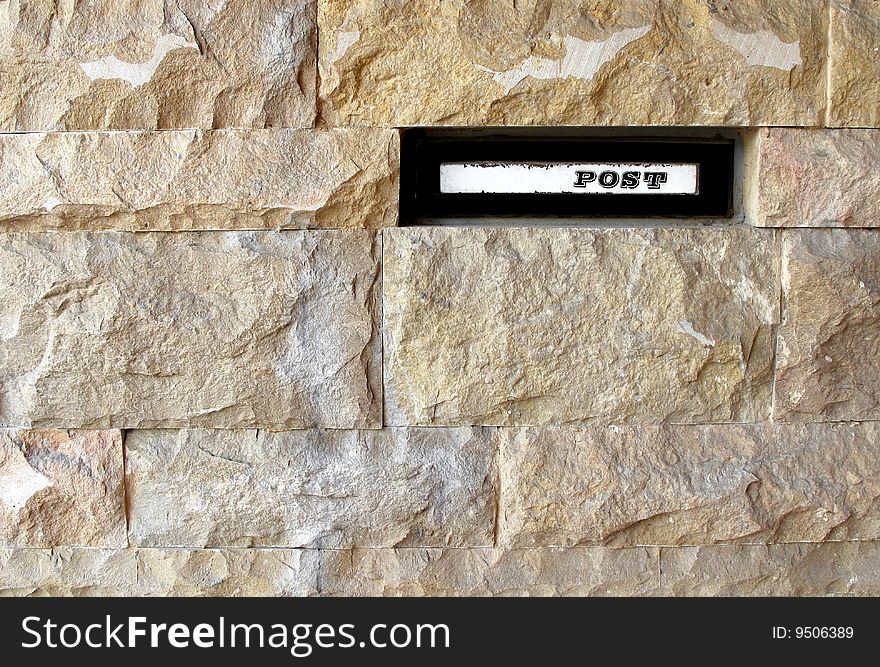 Letterbox in house stone wall