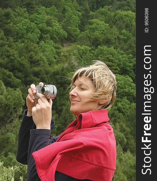 Women photographer in red dress on action