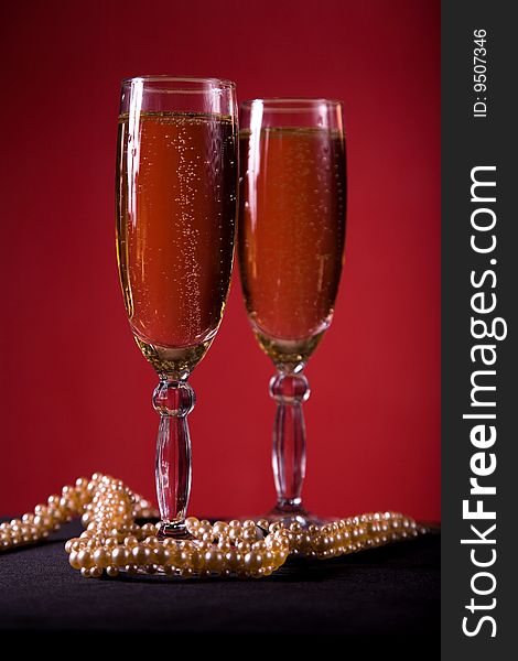 Champagne glasses with pearl necklace, selective focus
