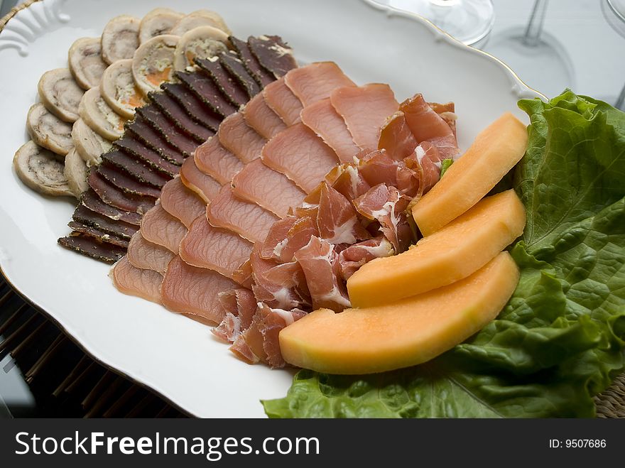 Meat slices assortment on a plate. Meat slices assortment on a plate