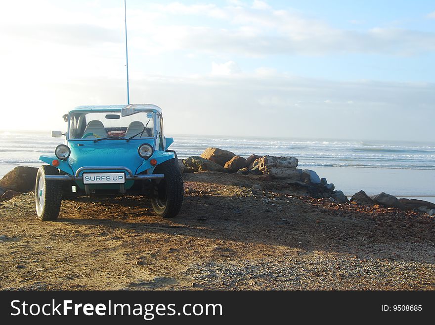 Beach buggie on beach with ocean in background