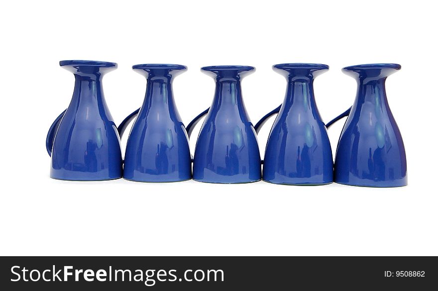 Row of five blue long-stemmed coffee cups upside down isolated. Row of five blue long-stemmed coffee cups upside down isolated
