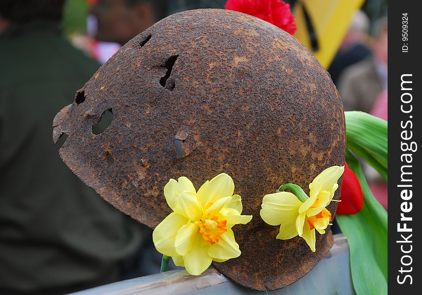 The soldier's helmet with the holes, decorated with flowers