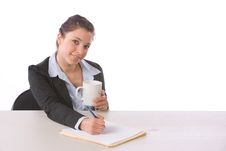 Business Woman Writing Notes At Desk Royalty Free Stock Photography