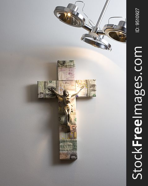 Well illuminated Cross in a wall symbol of money and religion