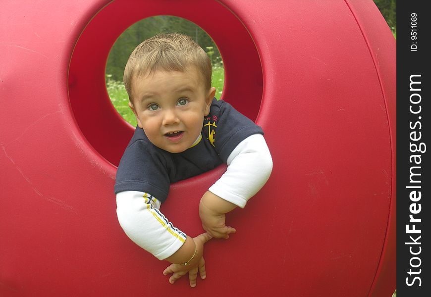 A baby in a red hole. A baby in a red hole