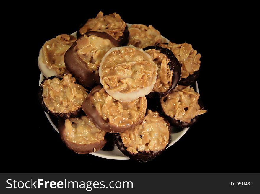 Tasty cookies on the plate on black