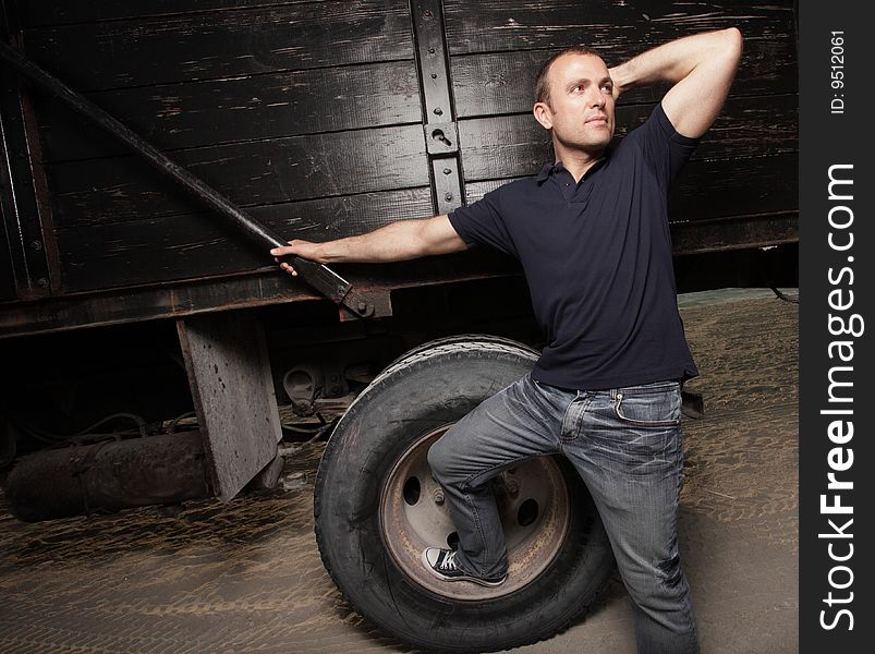 Man posing by a truck