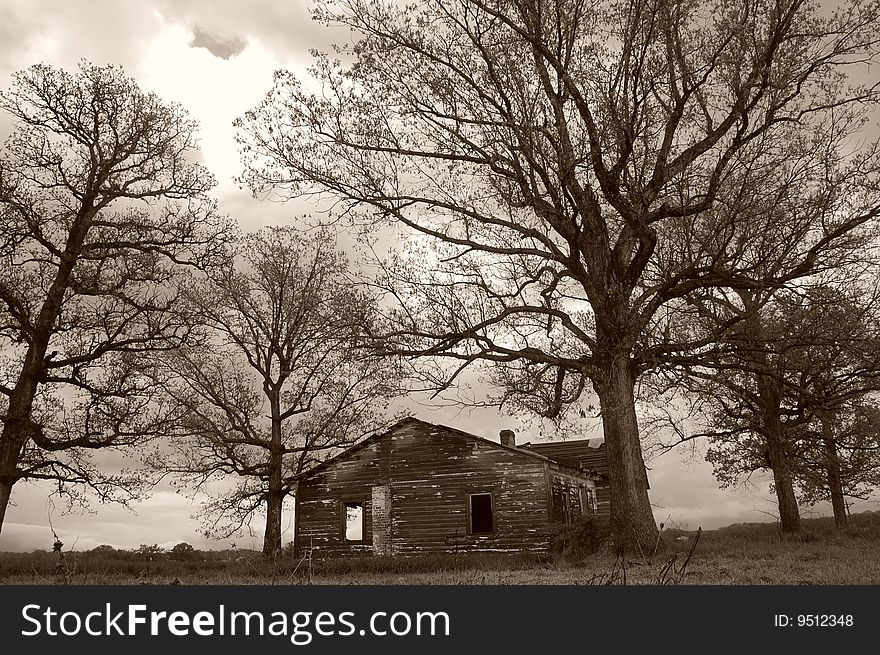 An abandoned farm house spotlighted by the sun. An abandoned farm house spotlighted by the sun.